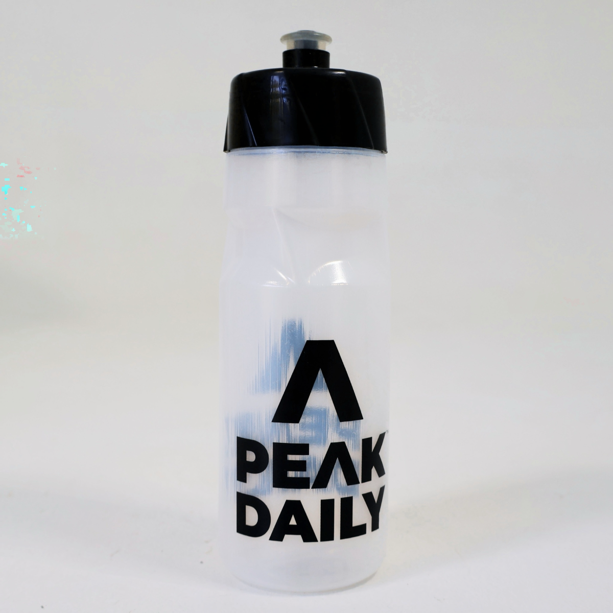 Clear water bottle with black cap and 'Peak Daily' text on a white background