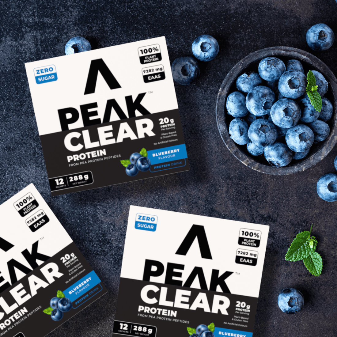 Box of Peak Clear Protein with passion pineapple flavor on a white background