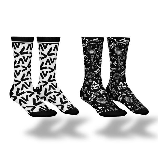 Two pairs of socks with black and white patterns on a white background