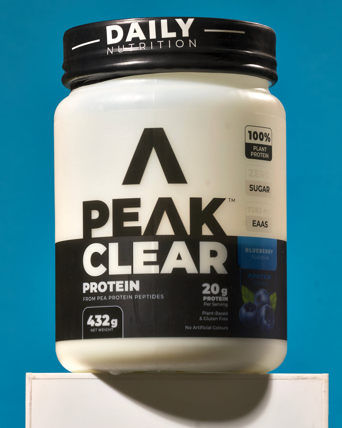 Peak Clear Protein container with black and white label blueberry flavour